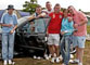 Vauxhall fans posing by their car